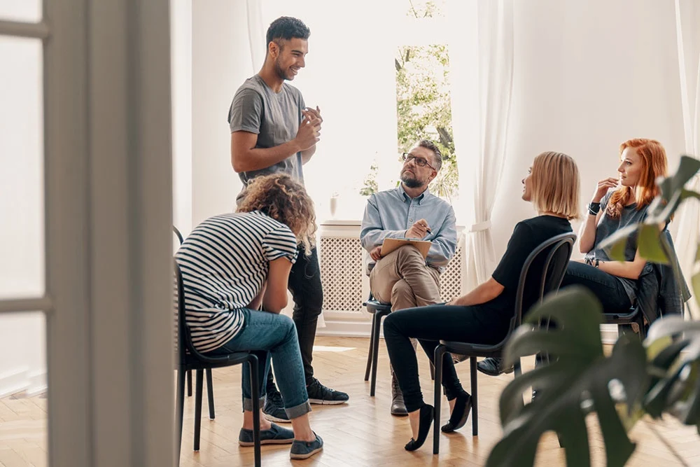 Support group sharing experiences about forgiveness and healing in recovery