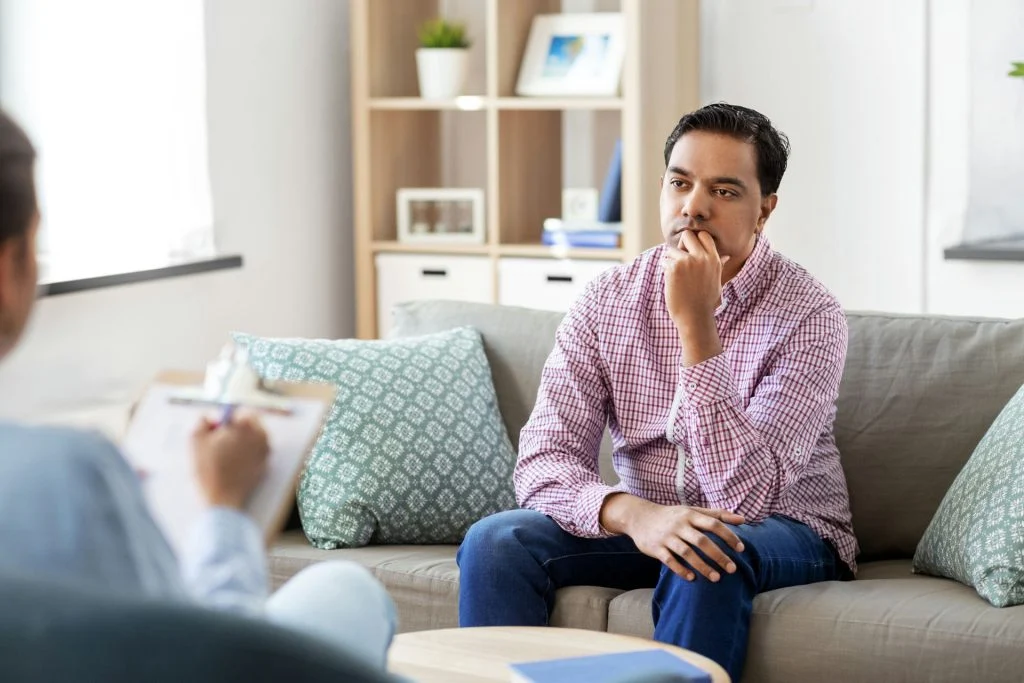 Man listening to his therapist explain the benefits of woodworking