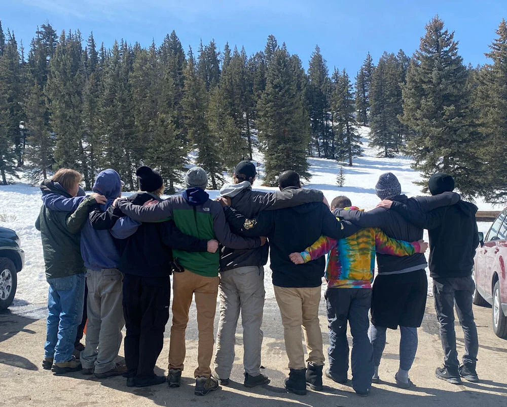Spero Alumni from men's residential program with their arms around each other in a line