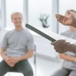man with notebook addressing support group for men