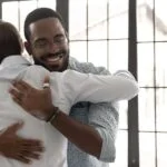 two men hugging during 12 step meeting