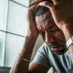 man with his head in his hands