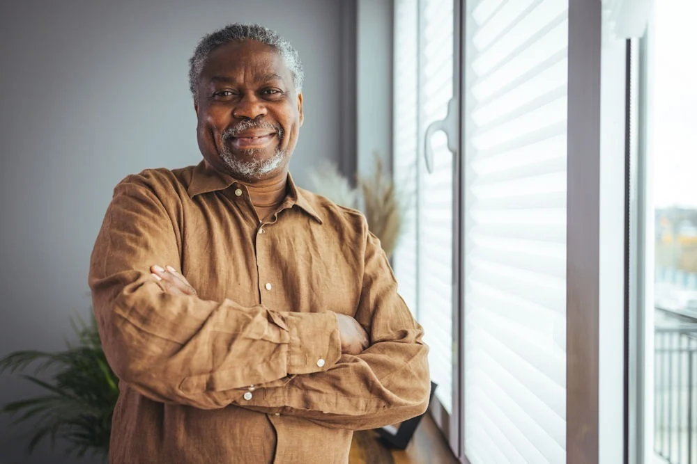 life-threatening-withdrawal-symptoms man standing by window smiling