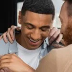 group of men hugging man in meeting