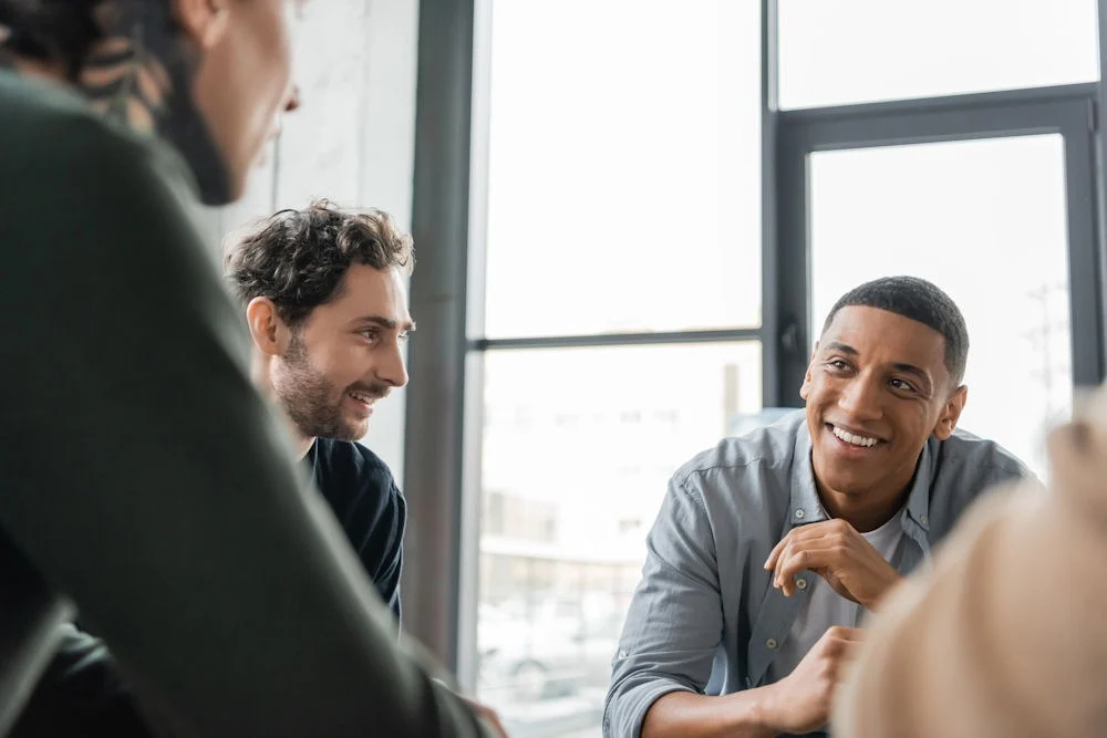 group of men welcoming a man to an aa meeting