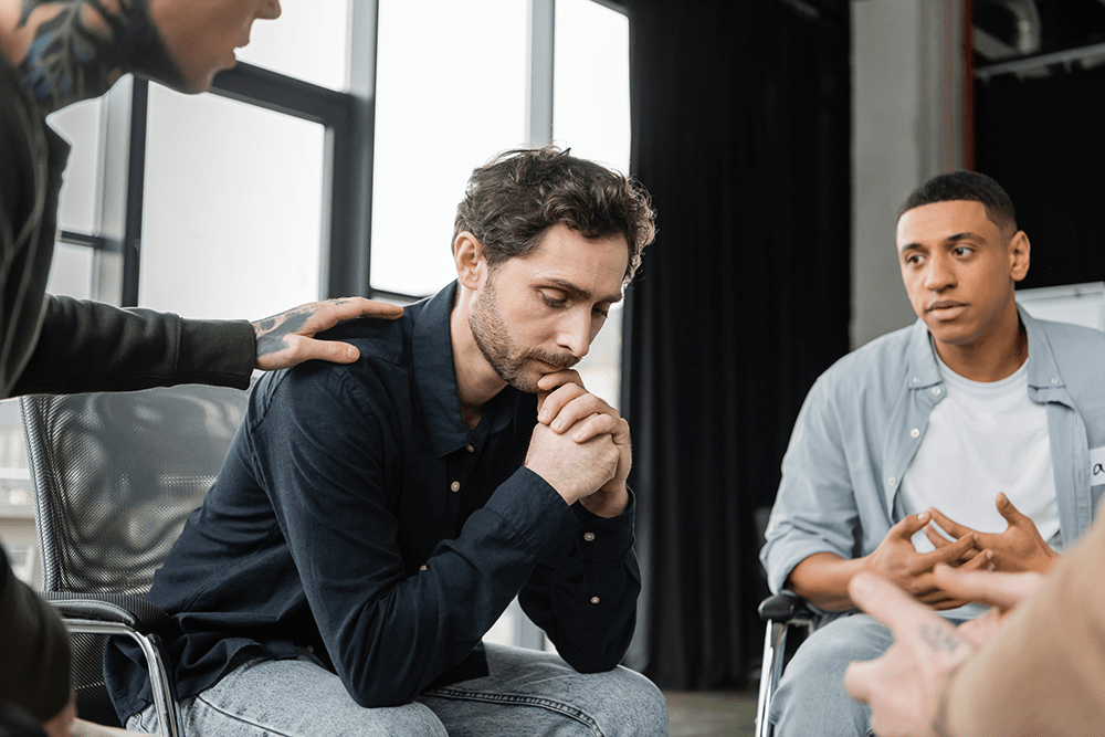Men participating in a gender-specific recovery group at a sober living home
