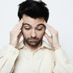 Adult experiencing dizziness and drowsiness, common side effects of mixing gabapentin and alcohol.