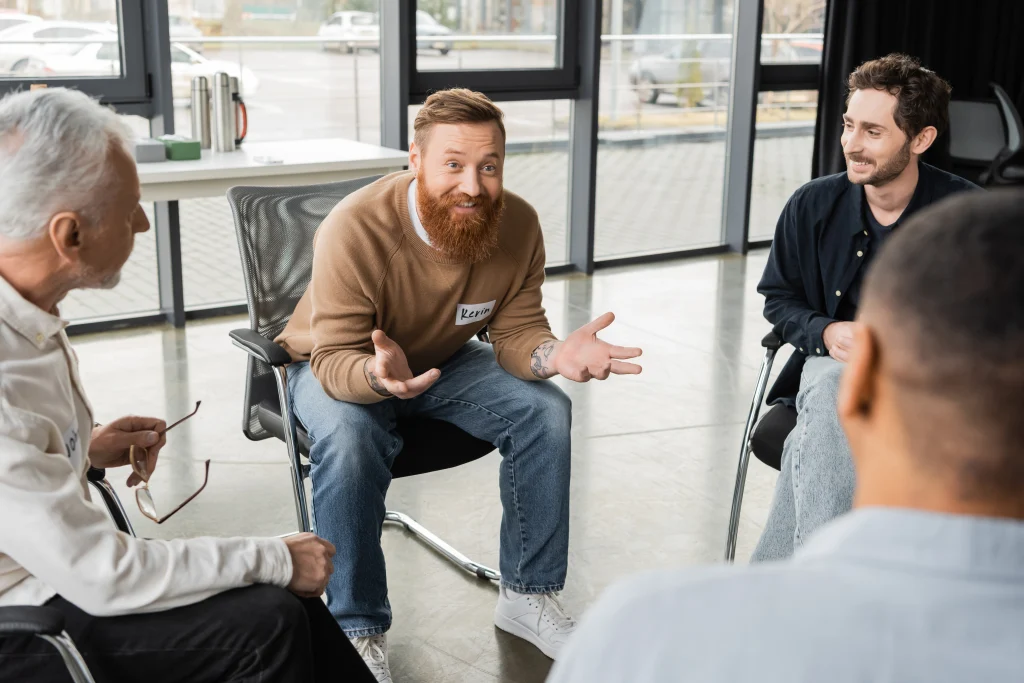 Men participating in a supportive peer-based group session at a residential rehab center.