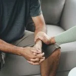 Mother talking to her adult son about drug addiction and addiction treatment options for young men