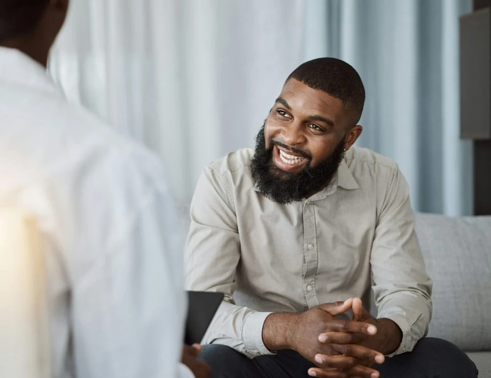 man attending a group therapy session in rehab