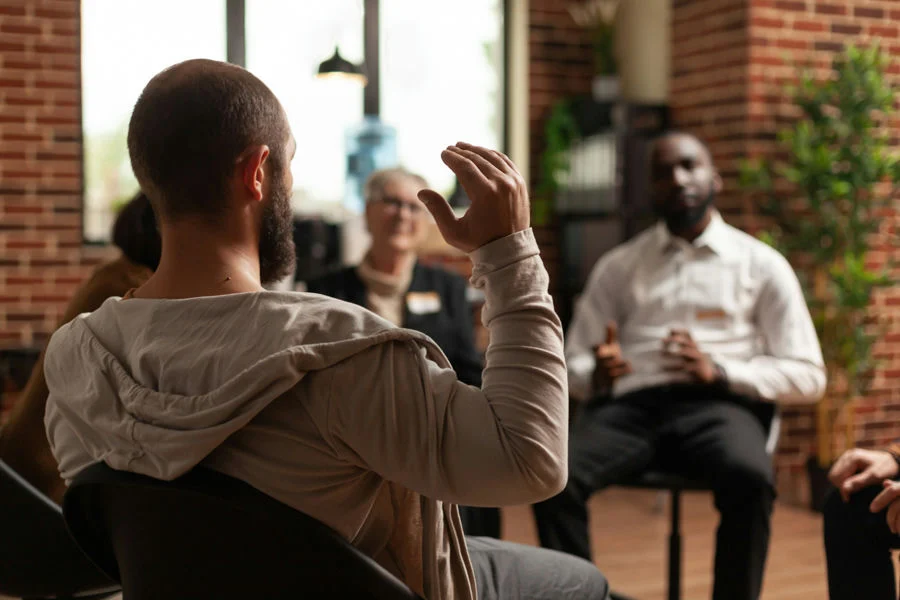 Men participating in group therapy for social anxiety and alcohol recovery.