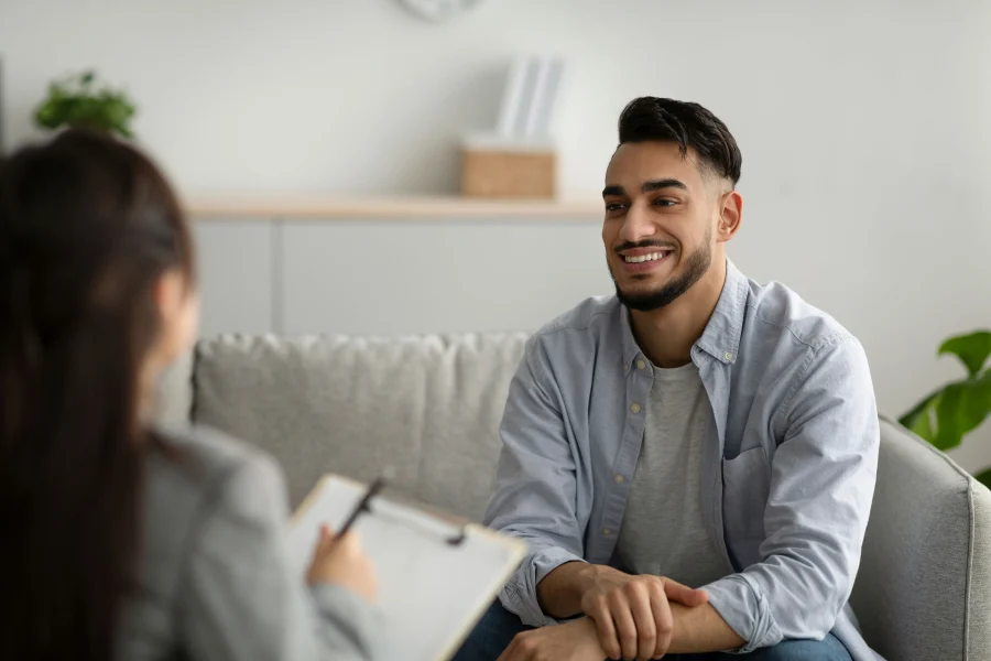 Young man receiving professional addiction counseling and mental health treatment