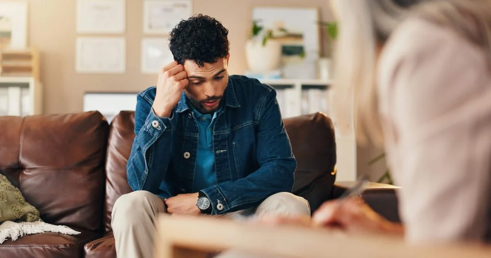 Addiction therapist helping a blue-collar worker address substance use and mental health challenges