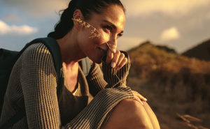 woman holding a piece of wheat grass and smiling
