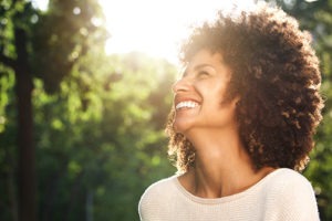woman looking at the sky smiling