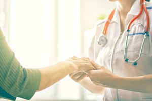 doctor holding a patients hands