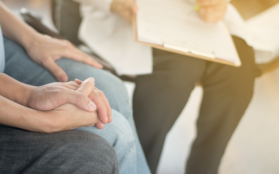 couple holding hands and sitting in therapy together