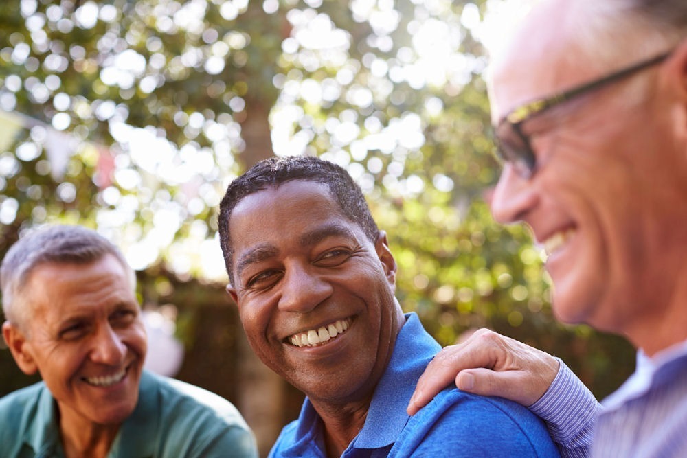 three men laughing together