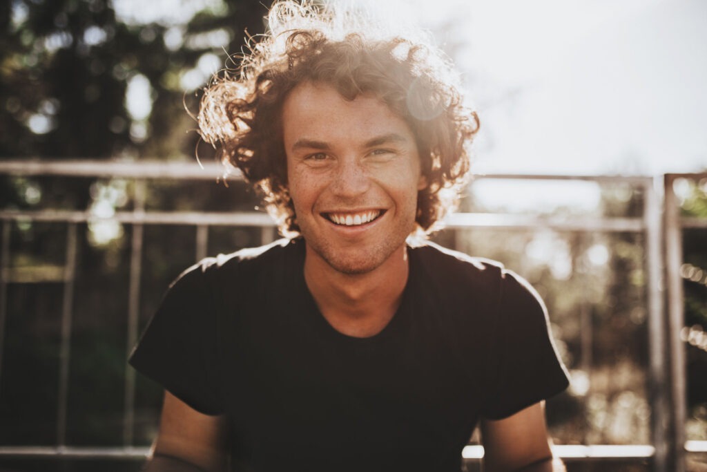 smiling young man with a dual diagnosis