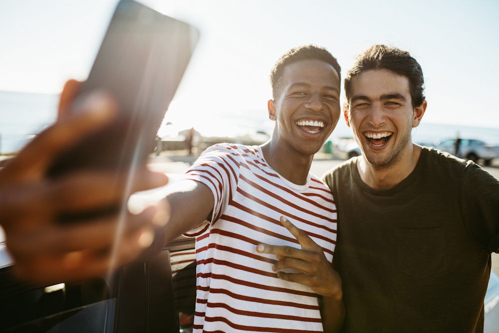 two men smiling and taking a photo together in recovery