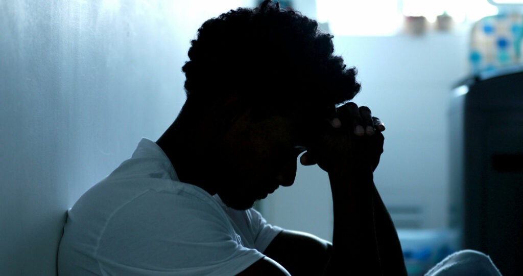 Unemployed man coping with depression and isolation after job loss.